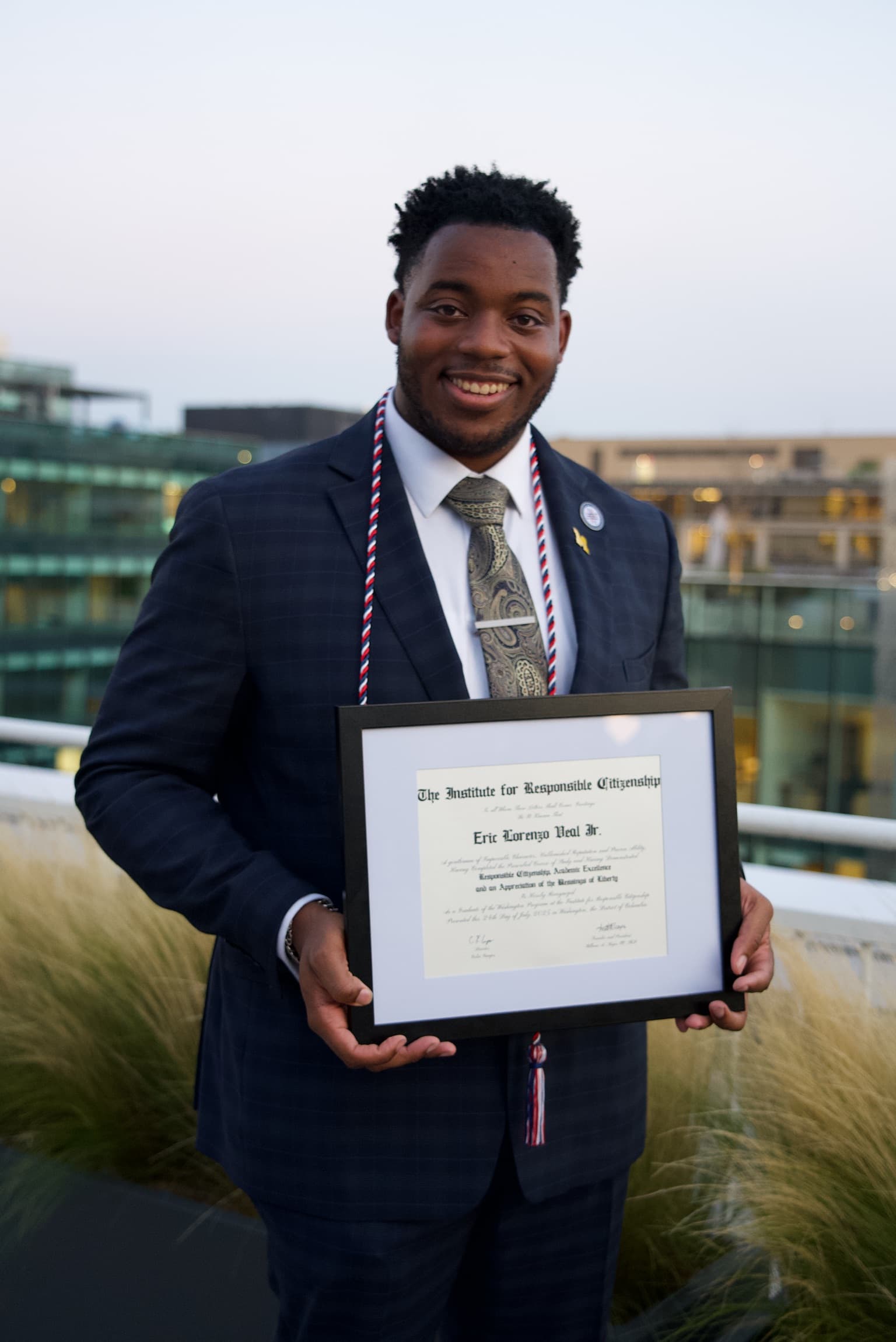 Eric Veal holding his Washington Program diploma